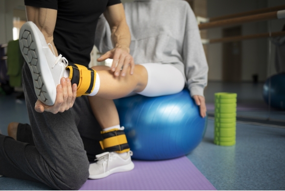 patient-doing-physical-rehabilitation-helped-by-therapists