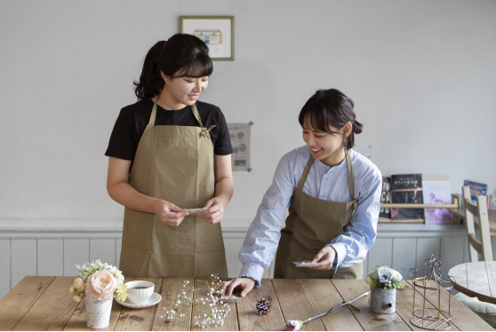young-women-arranging-their-cake-shop
