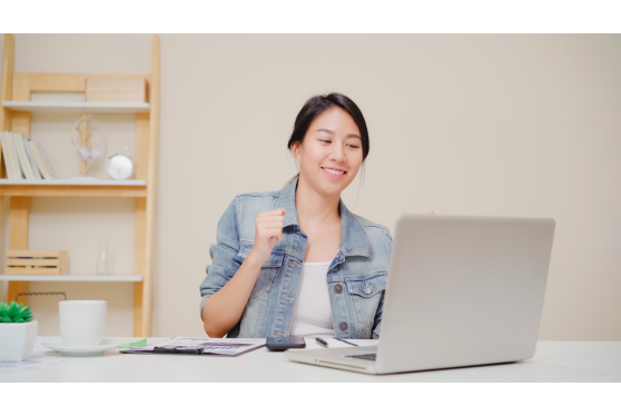young-asian-woman-working-using-laptop-desk-living-room-home-asia-business-woman-success-celebration-feeling-happy-dancing-home-office